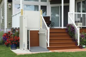 vertical platform lift — enclosed VPL beside home entrance